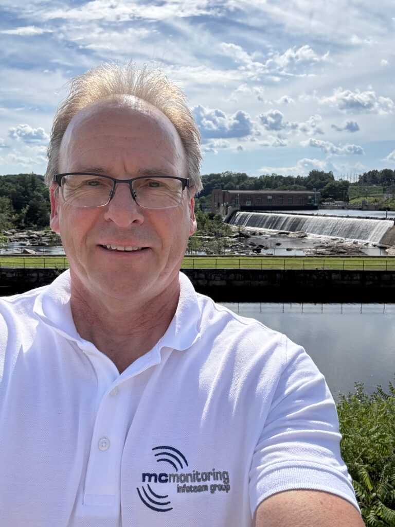 sjur-holm-condition-monitoring-north-america-mcmonitoring Sjur Holm representing MC-monitoring in North America, standing in front of a hydroelectric power plant.